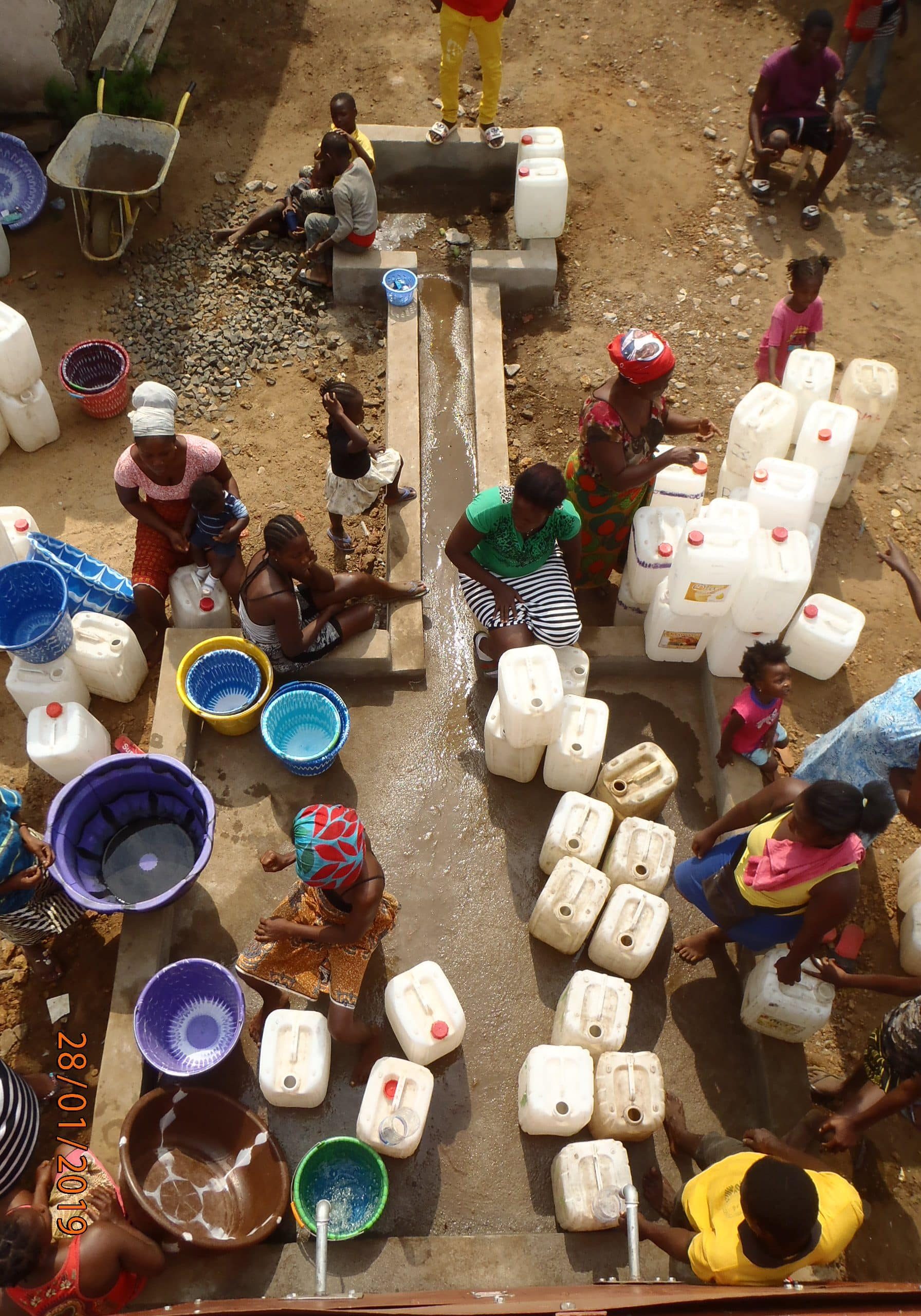 Women fetching water with jerrycans at a water point